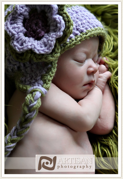 baby girl with purple and lavender aviator hat close up