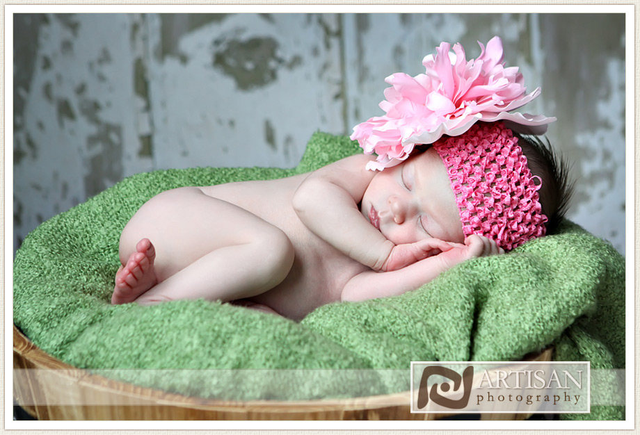 baby girl with pink bow in a basket