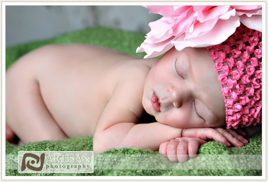 baby girl with pink bow in a basket