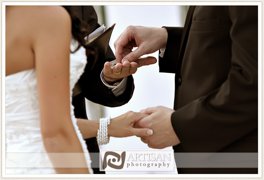 bride and groom exchanging rings during ceremony