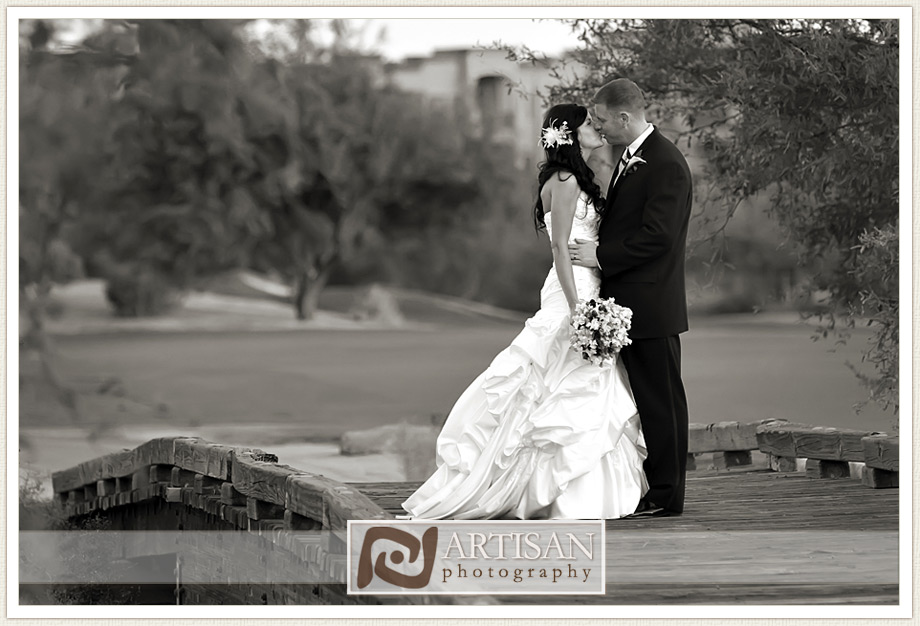 Bride and Groom kissing on the bridge