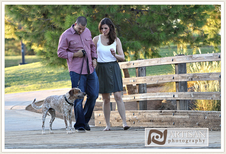 engagement photos at the park in Gilbert couple with sports jerseys kissing from the back