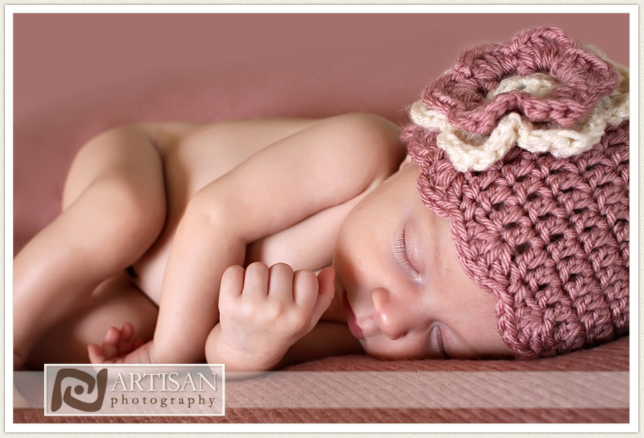 newborn baby girl photo with pink blanket and pink hat with flower