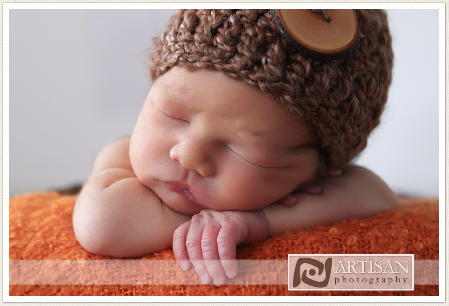 close up of baby face with brown hat - photography prop
