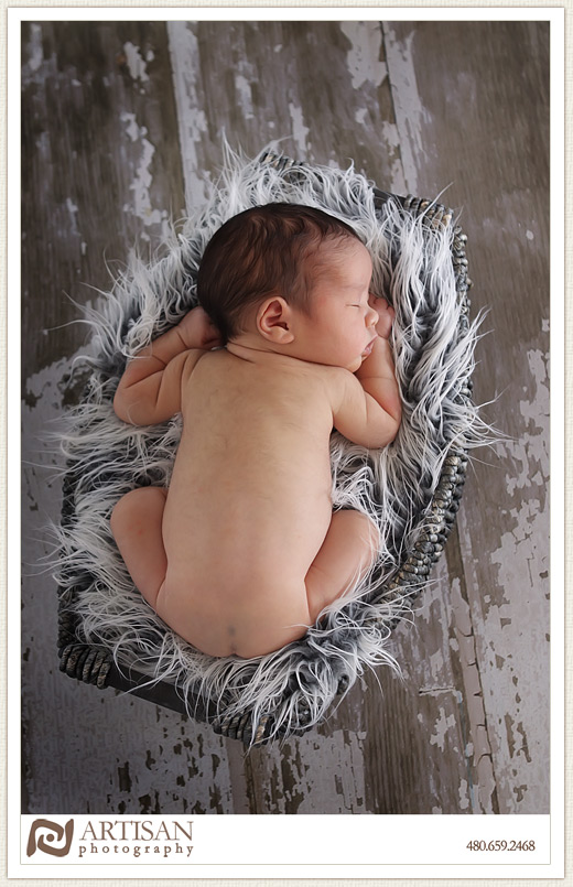 baby in basket on old flooring