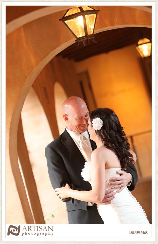 Royal Palms Wedding image of bride and groom kissing under arch 