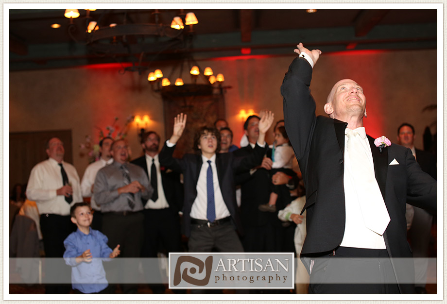 Royal Palms Wedding image of  groom tossing garter