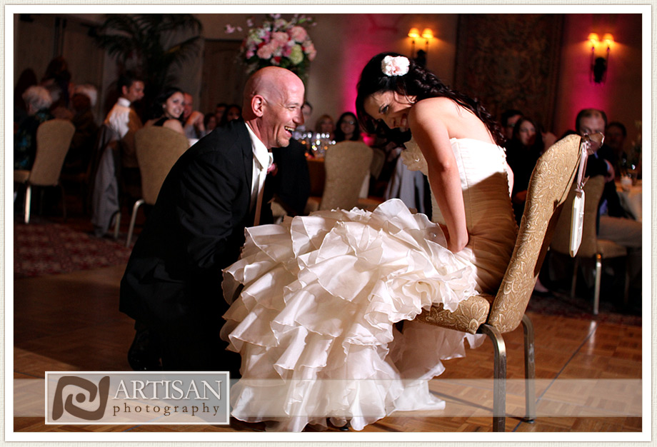 Royal Palms Wedding image of  groom removing the garter