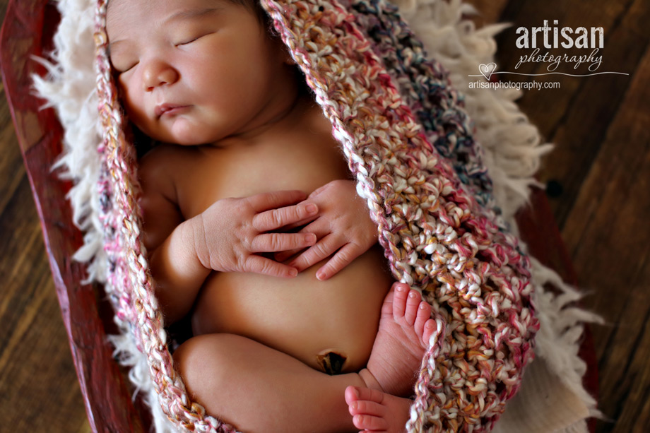 newborn baby girl in a pink cocoon closeup newborn photo