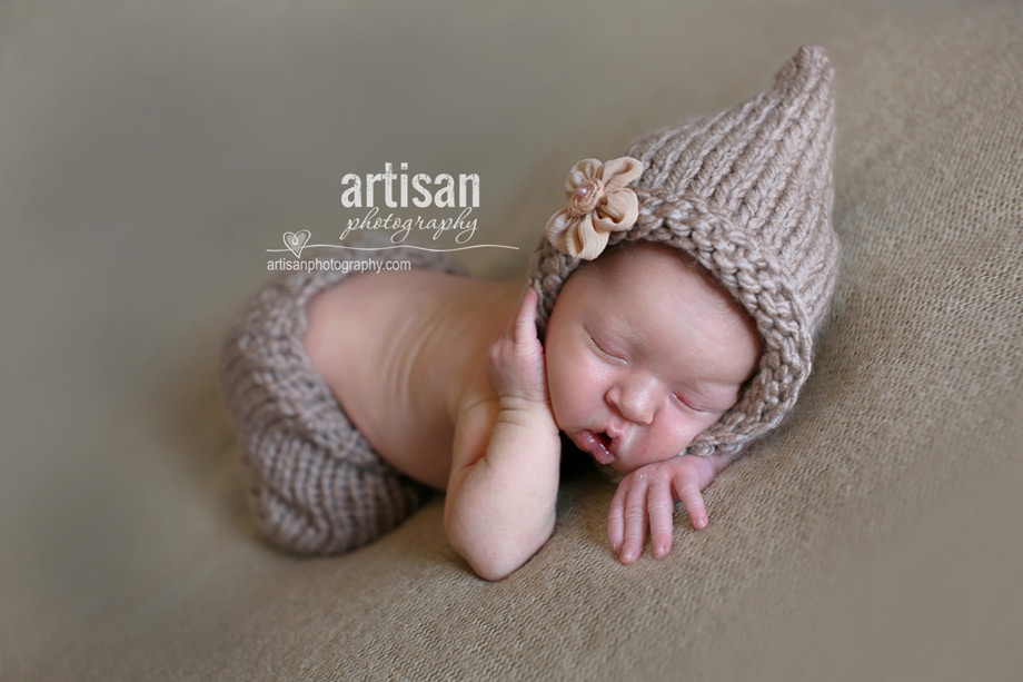 cute baby girl pose in beije pants and hat