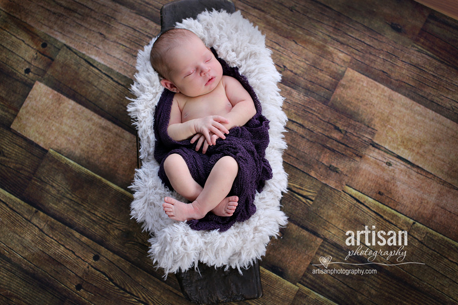 baby girl laying in basket with purple banket at the artisan studio in carlsbad