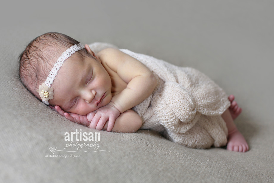 newborn baby girl photo at our Carlsbad studio in California in cream wrapp and headband