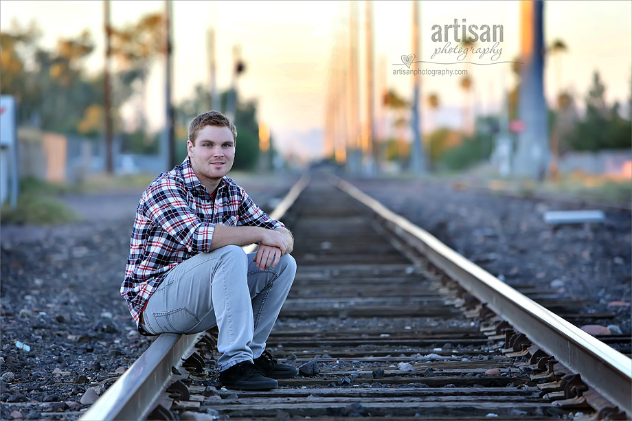 High school senior boy photo on train tracks