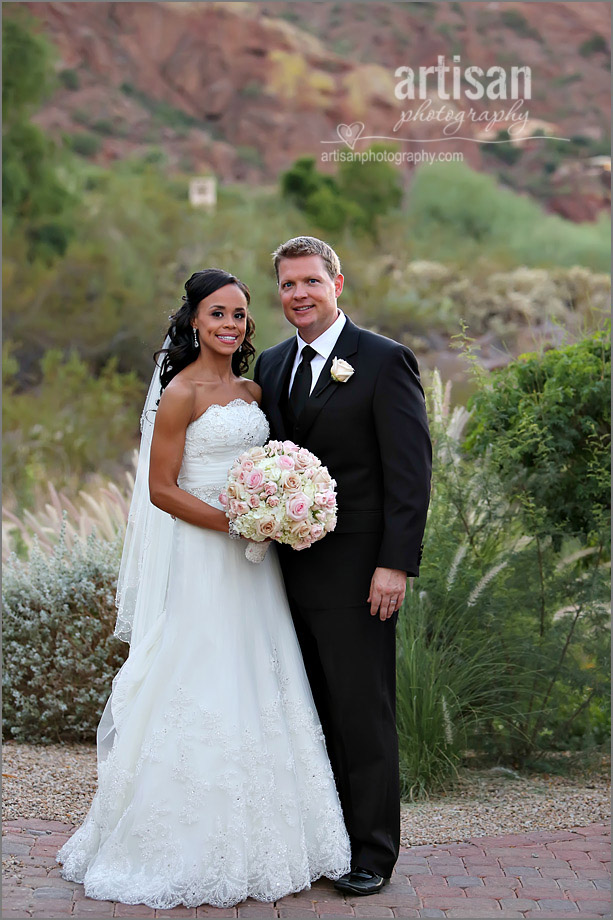 bride and groom on wedding day at Sanctuary Camelback Mountain resort holding beautiful flower bouquet