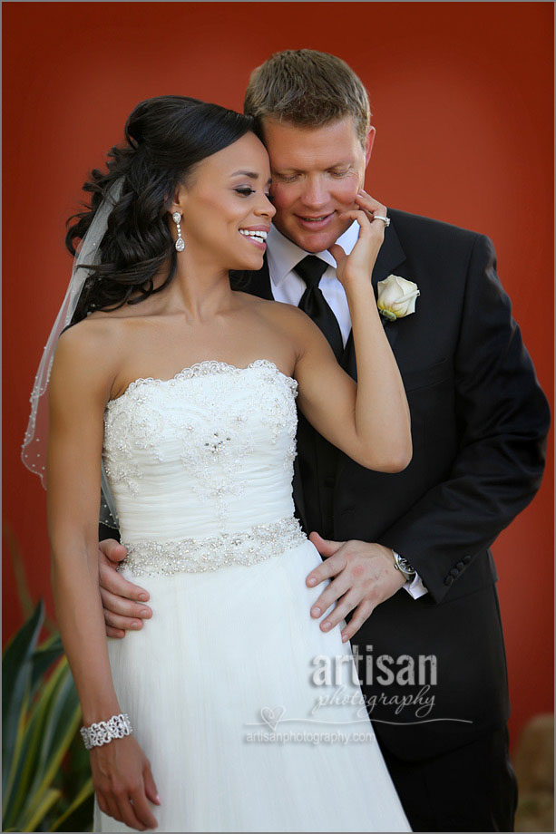 Bride & Groom during their reveal at The Sanctuary Mountain on a red wall background