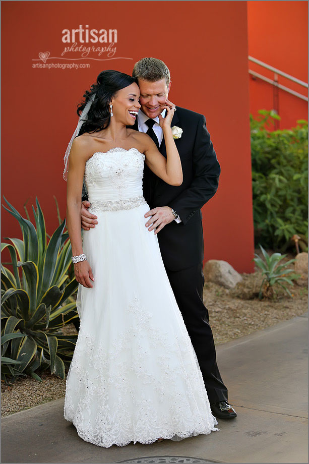 Bride & Groom during their reveal at The Sanctuary Mountain on a red wall background