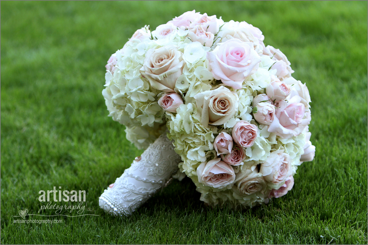 Bride bouquet on the grass made with hydrangeas pink and chanpagne roses