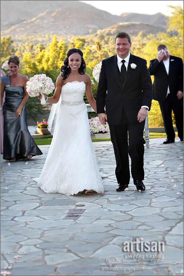 Bride and groom walking out of ceremony site