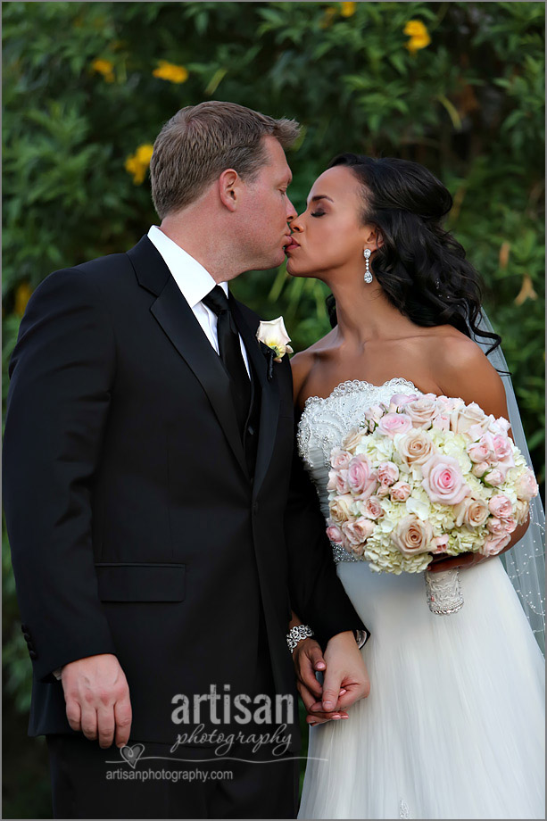 Bride and Groom on a walk kissing