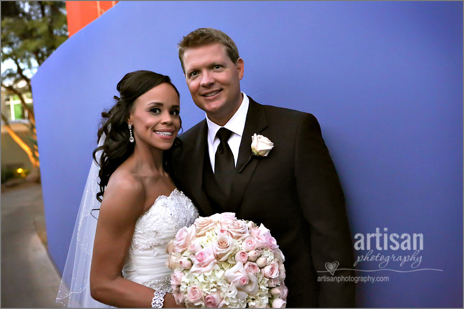 bride and groom on blue wall