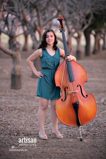 High School Senior photo of girl on a orchard with her music instrument