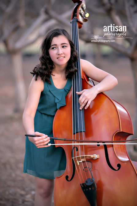 High School Senior photo of girl on a orchard with her music instrument