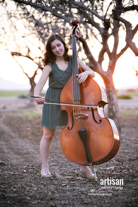 High School Senior photo of girl on a orchard with her music instrument