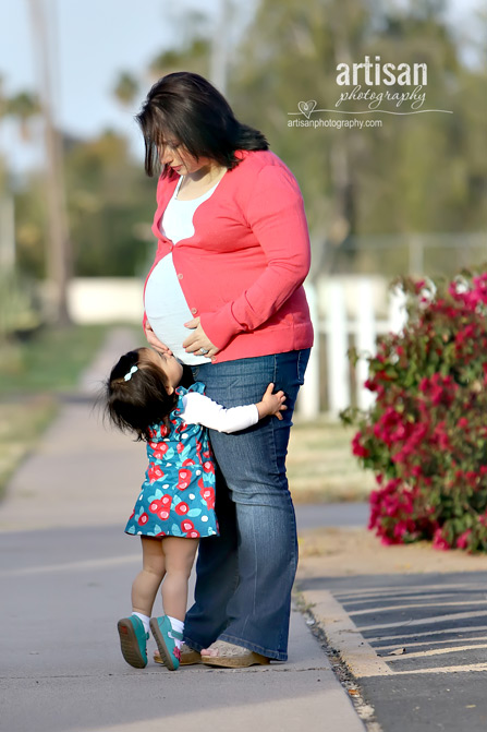 toddler kissing pregnant mother's tummy