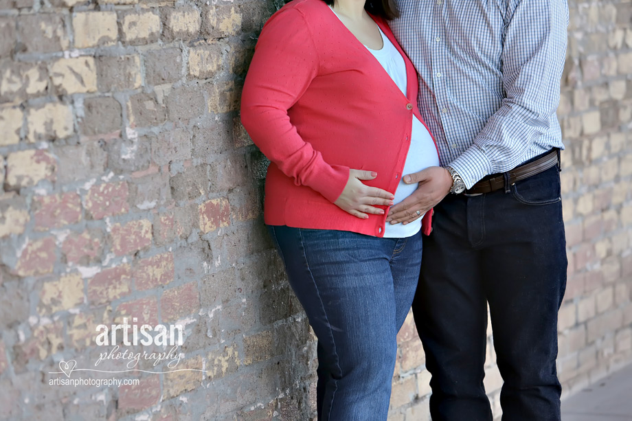 close up shot of couple holding future mom's tummy