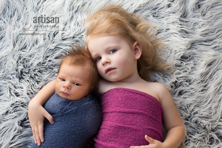 professional photo of newborn baby and his sister