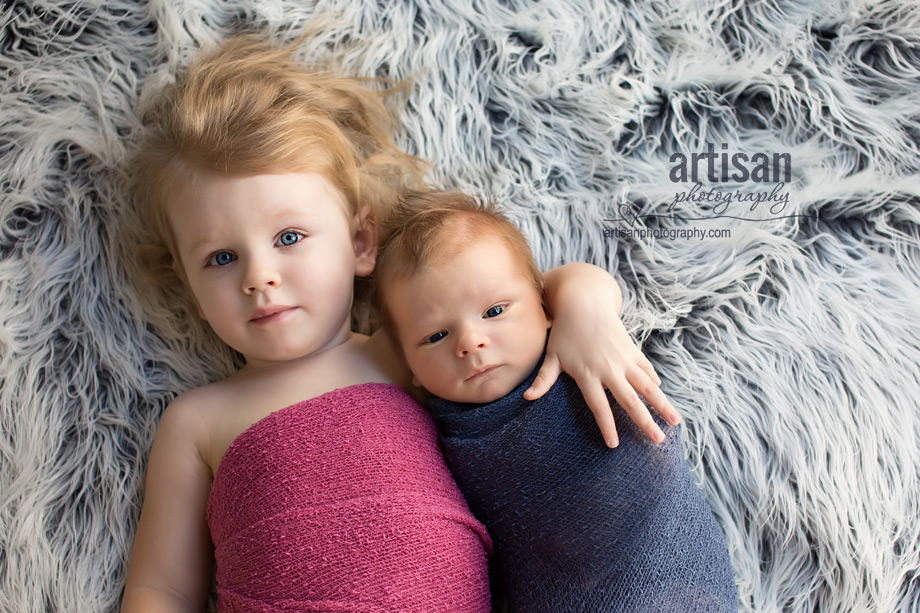 professional photo of newborn baby and his sister