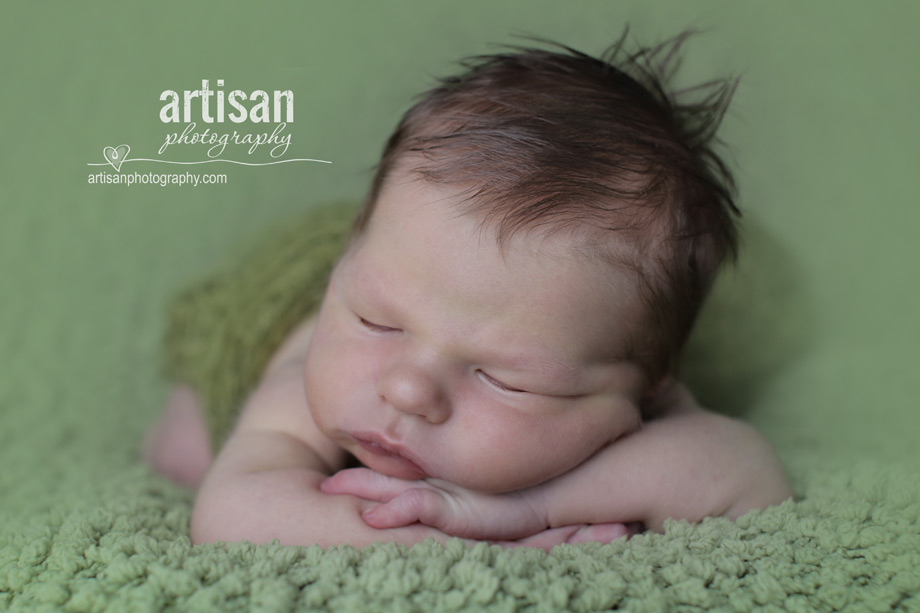 professional photo of newborn baby on green blanket