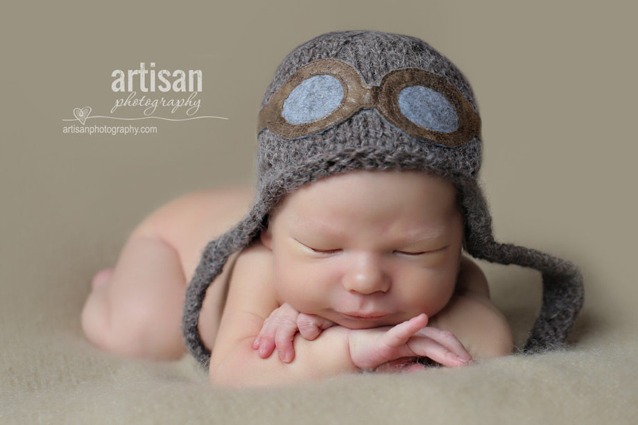 professional photo of newborn baby with aviator hat