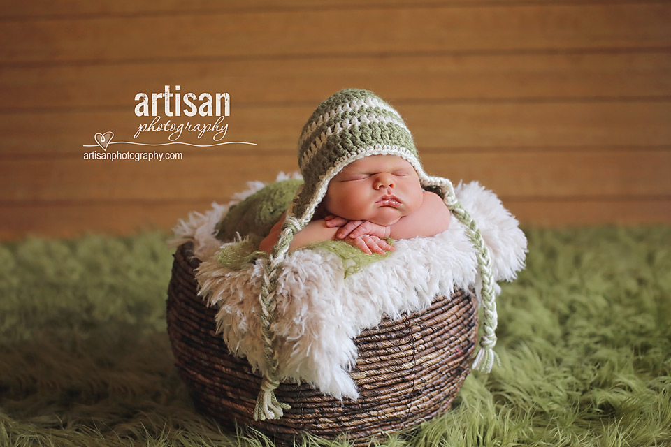 newborn baby boy photo laying on a basket in Carlsbad California