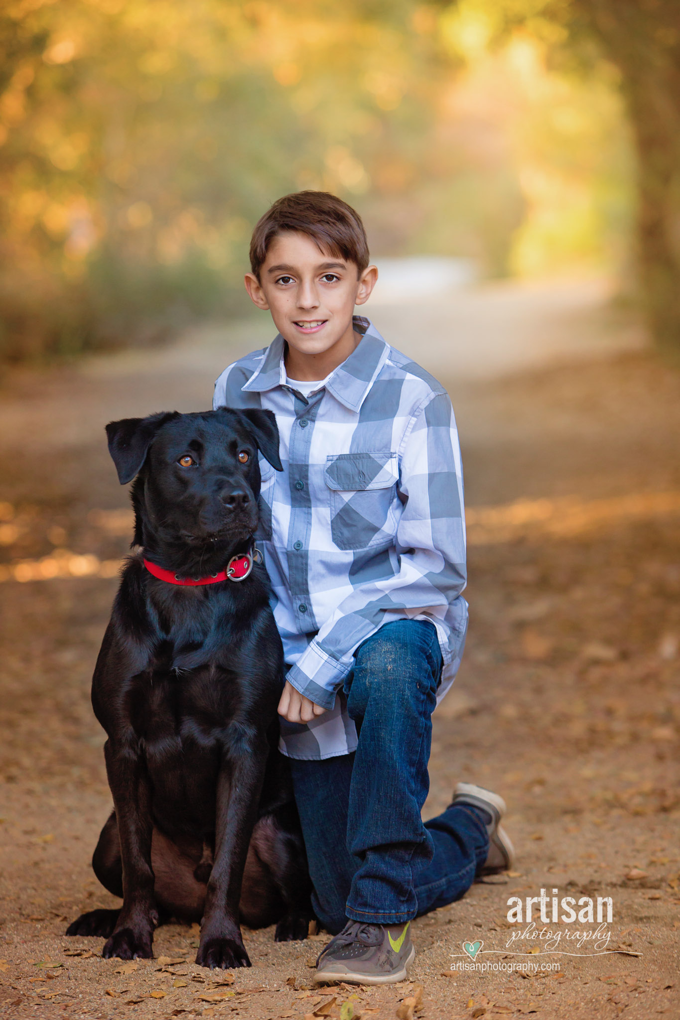 Beautiful photo out in a trail of Boy and his dog.