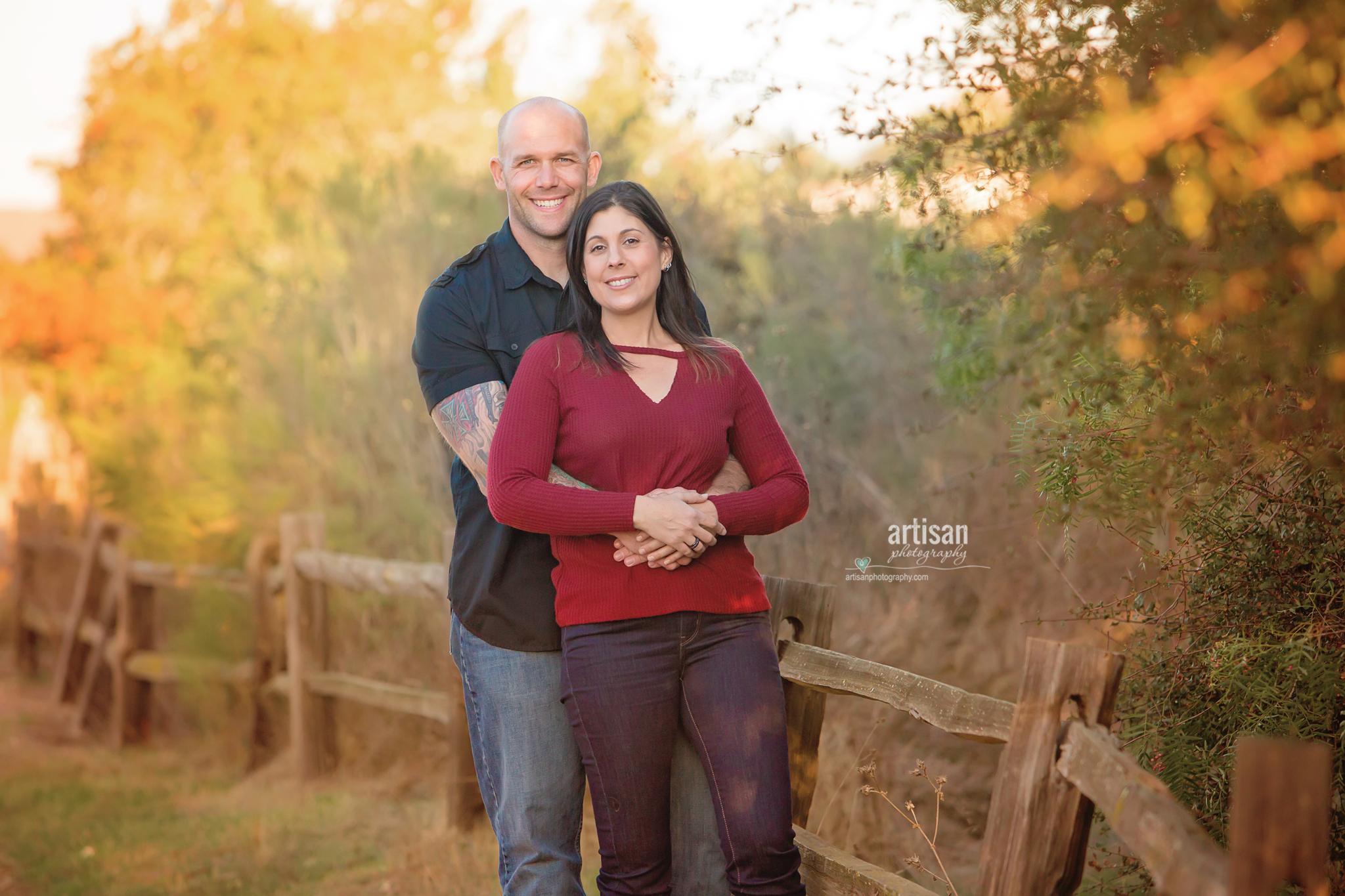 San Diego Family Engagement session happy couple by the wooden fence, beautiful trail and trees