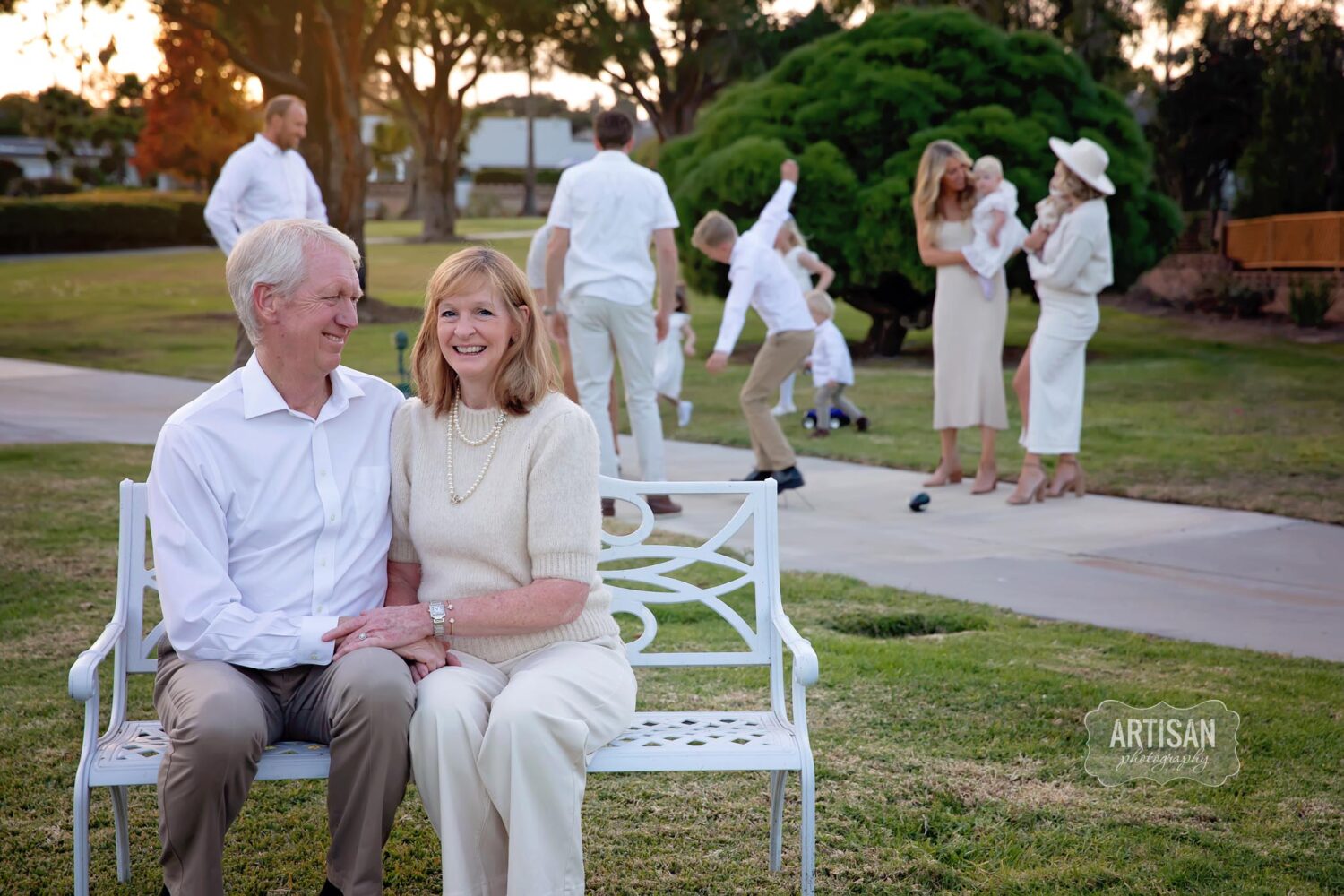 Photo of grandparents with kids and grandkids playing in the background. Carlsbad, California