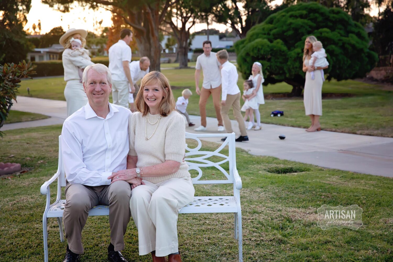 Photo of grandparents with kids and grandkids playing in the background. Carlsbad, California