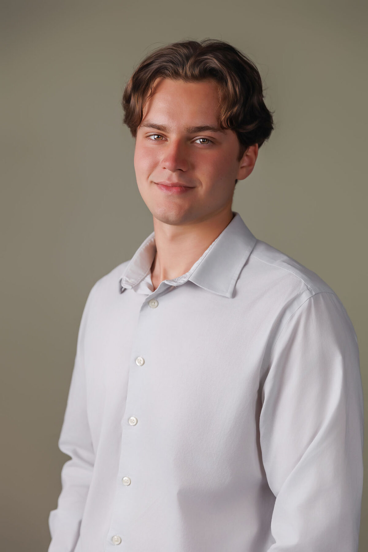 male headshot on tan backdrop